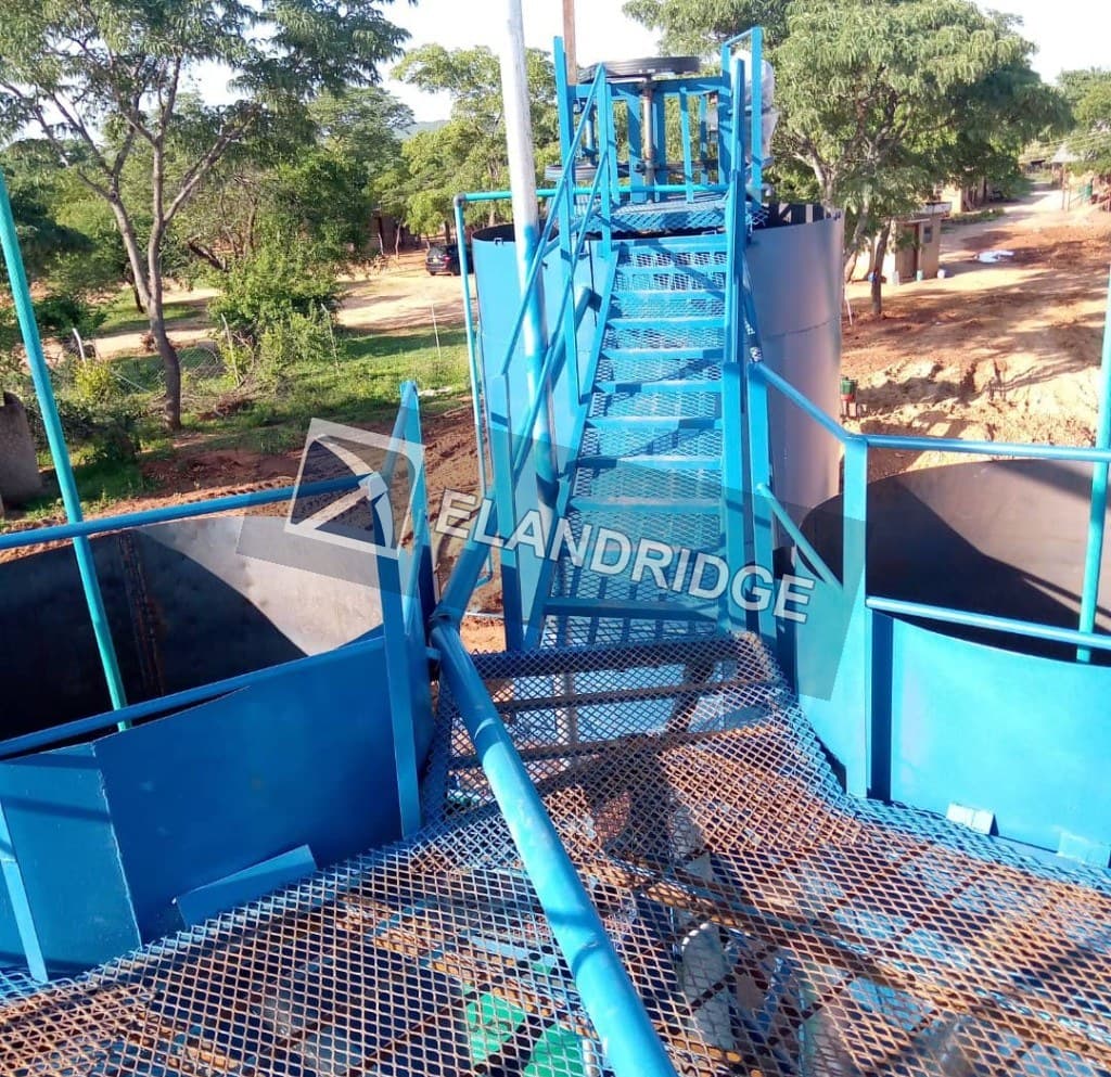 Blue CIP tanks, stairs and walkways at Kambuzi