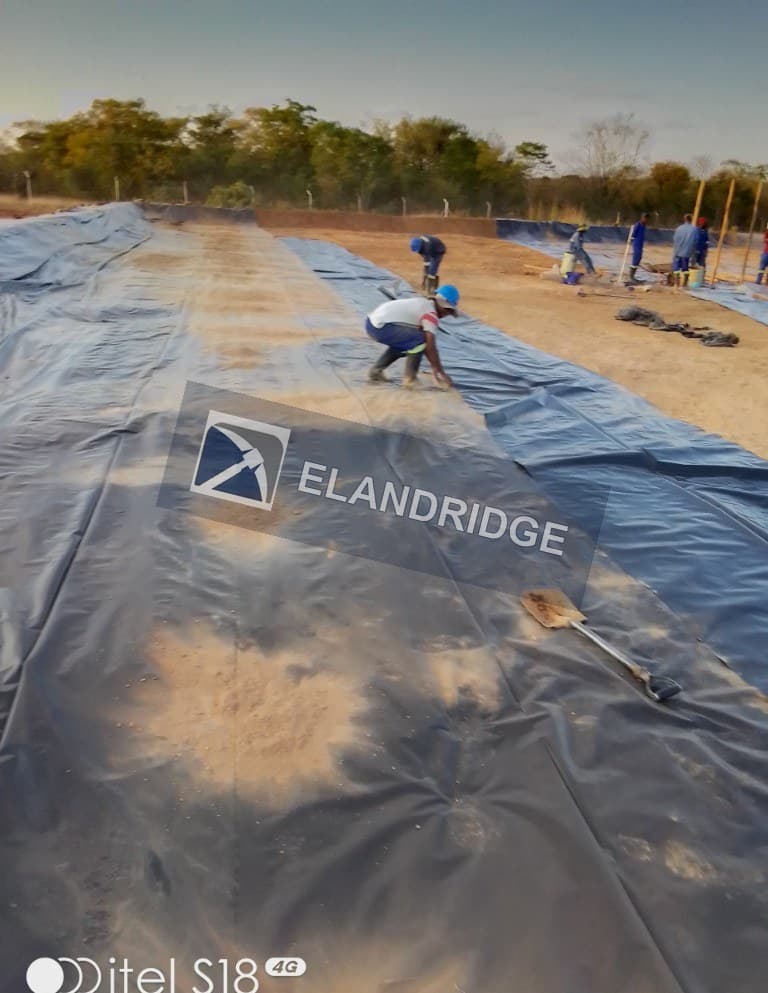 Crew installing pond liner at the Kambuzi CIP plant