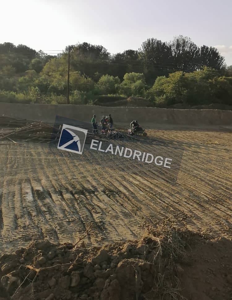Crew preparing the compacted leach pad
