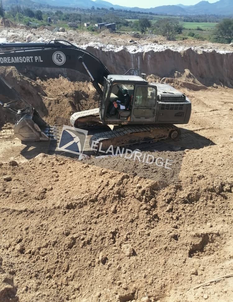 Excavator in the heap leach earthworks