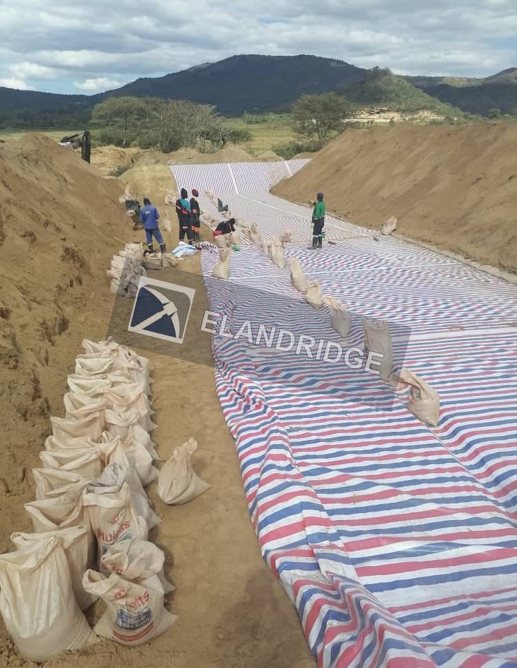 Lined collection trench with sandbags holding the membrane