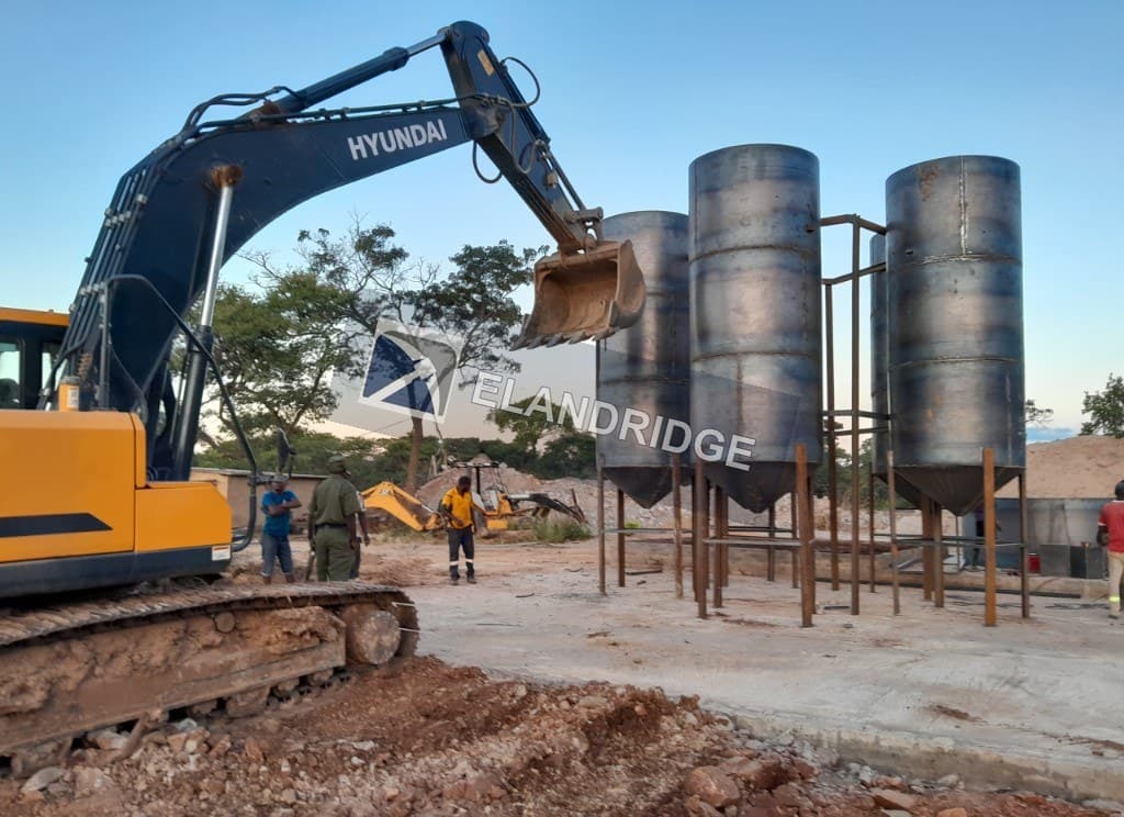 Excavator beside CIP tanks during installation